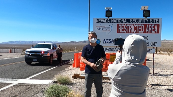 Director Ito, speaking in front of the entrance to the Nevada National Security Site, formerly known as the Nevada Test Site and earlier, the Nevada Proving Grounds (July 2022)
